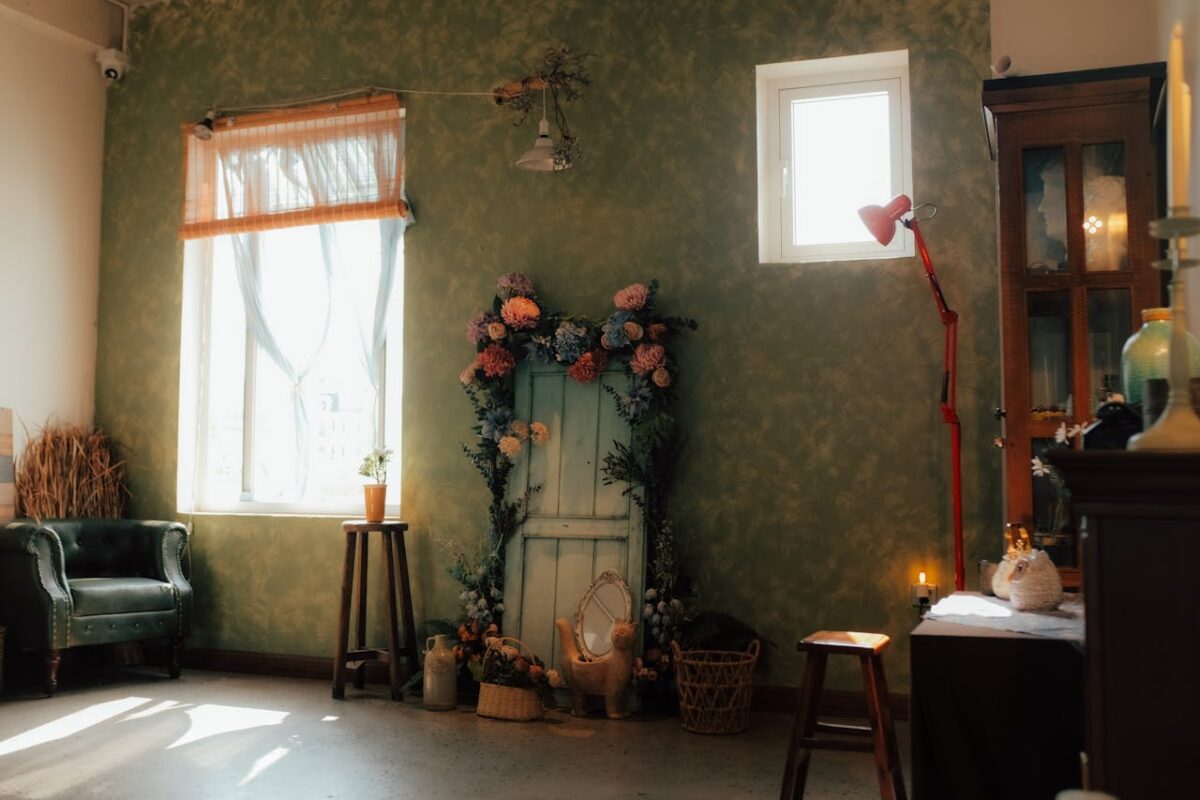services-04 A charming vintage room featuring floral decor, natural light, and cozy furniture.